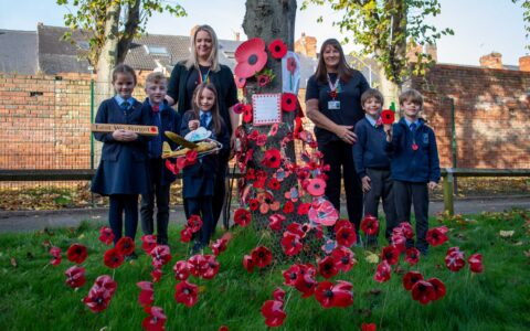 Hucknall National C of E Primary School children create Remembrance poppy display
